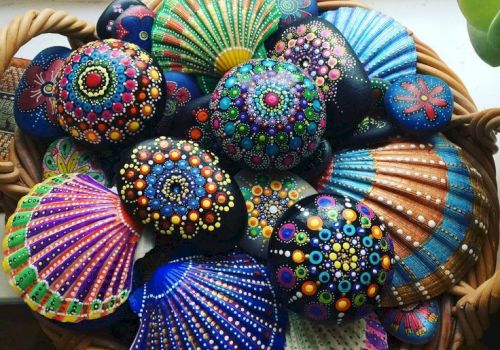 Colorfully painted decorative shells in a wicker basket near a window.